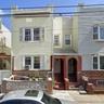 Townhome / multi-family property featuring brick siding and cooling unit