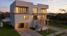 Contemporary house with stairs, a balcony, stucco siding, and concrete driveway