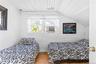 White-painted wood-plank walls and ceiling with sloped architectural detail