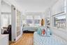 Bright interior space featuring wood-finish flooring and white vertical paneling