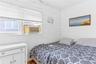 Room featuring white shiplap walls, smooth white ceiling, and a window air conditioning unit