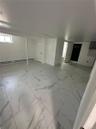 Open concept room featuring large format tile flooring, white painted walls, and recessed lighting