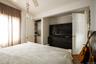 Room featuring wood-finish flooring, a ceiling fan, and a window with neutral-toned curtains