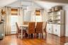 Vaulted ceiling dining area featuring rich wood-finish flooring