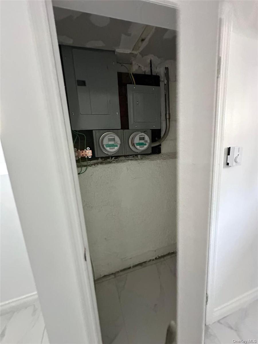 Electrical panels and utility meters are visible within a utility closet