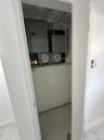 Electrical panels and utility meters are visible within a utility closet