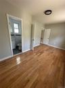 Warm wood-finish flooring complements the neutral wall tones