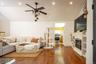 Spacious living area featuring vaulted ceilings, recessed lighting, and wood-finish flooring