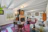 Exposed beam ceiling, arched window, built-in fireplace, wood-finish flooring, recessed lighting