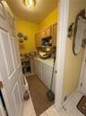 Laundry with a sink, shelving, cabinets and more