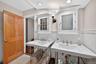 Bathroom featuring tile walls and a wainscoted wall
