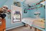 Bedroom #4 with a baseboard radiator, carpet floors, and ornamental molding