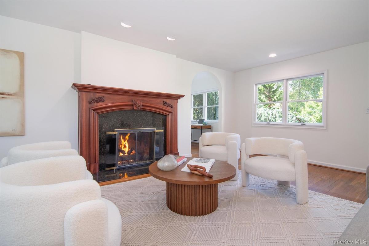 Sitting room featuring a premium fireplace, wood finished floors, and recessed lighting