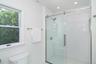 Full bath featuring a stall shower and toilet