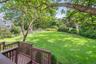 Fenced backyard featuring a deck