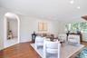 Living area featuring wood finished floors, arched walkways, and recessed lighting