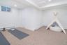 Workout room featuring carpet flooring, a baseboard radiator, and recessed lighting