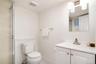 Full bathroom with vanity, light tile patterned floors, and a shower with door