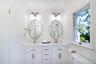 Full bathroom featuring double vanity and a shower