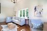 Living room featuring wood finished floors, a chandelier, and high vaulted ceiling