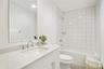 Full bathroom featuring tiled shower / bath, vanity, and toilet