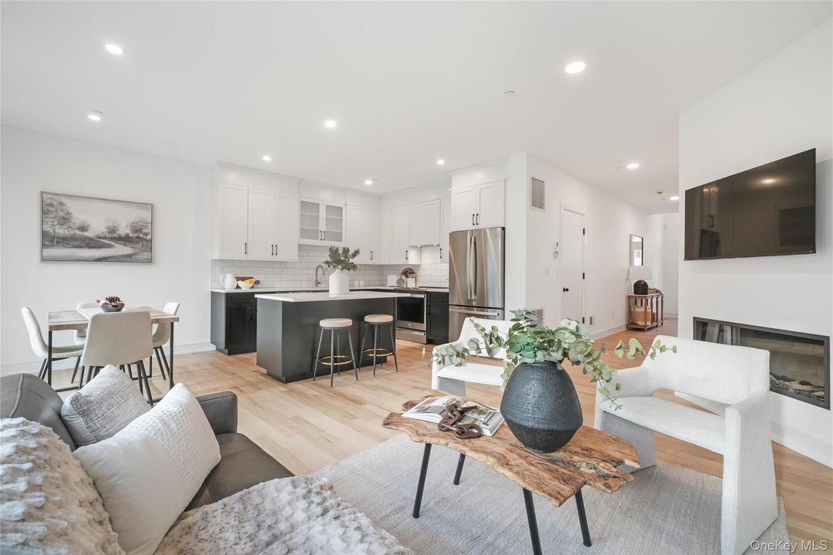 Living room featuring sink and light hardwood / wood-style flooring