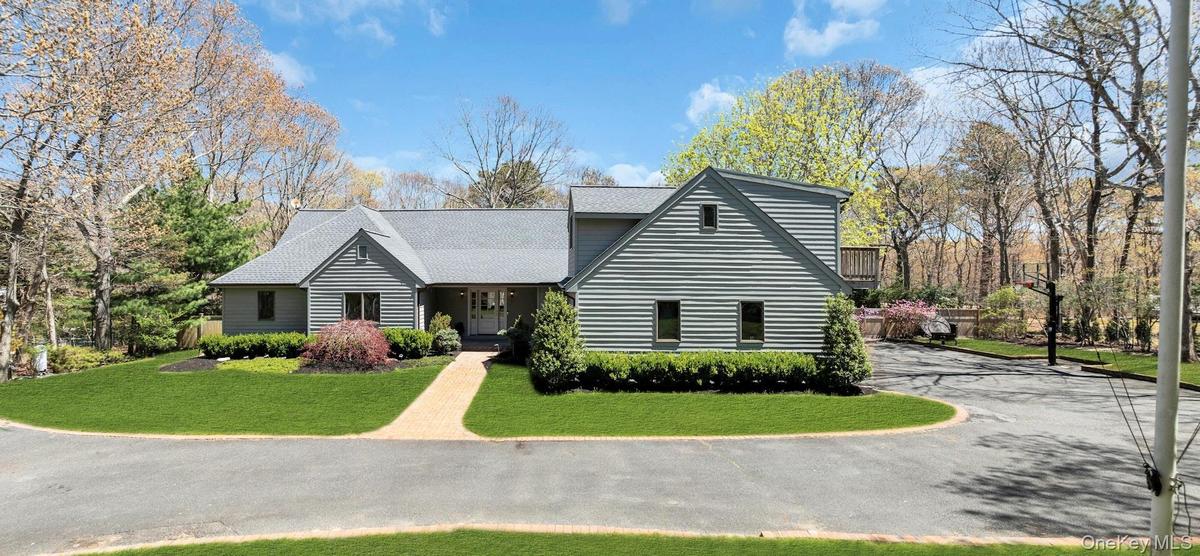 Contemporary-style residence with gray horizontal siding and a light gray shingle roof