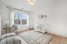 Bedroom featuring a nursery area and light hardwood / wood-style floors