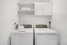 Laundry room featuring cabinets and washing machine and clothes dryer