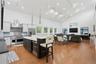 Open-concept living area featuring a vaulted ceiling with recessed lighting, wood-finish flooring, a gourmet kitchen with stainless steel appliances, 