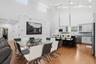 Open-concept living space featuring high vaulted ceilings and light wood-finish flooring