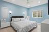 Carpeted bedroom featuring recessed lighting, a ceiling fan, and multiple windows