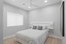 Spacious room featuring neutral paint tones, recessed lighting, a modern ceiling fan, a large window with roller shades, and plush carpeting