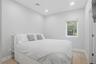 Bright room featuring a single window, recessed lighting, and light-colored carpeting