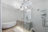 Primary bathroom with luxury finishes in Wellington FL rental home with soaking tub and shower.