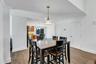Dining area featuring wood-finish flooring and a central pendant light fixture