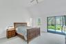 Vaulted ceiling room featuring light gray carpet flooring and white walls