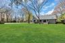 Expansive green lawn with mature trees