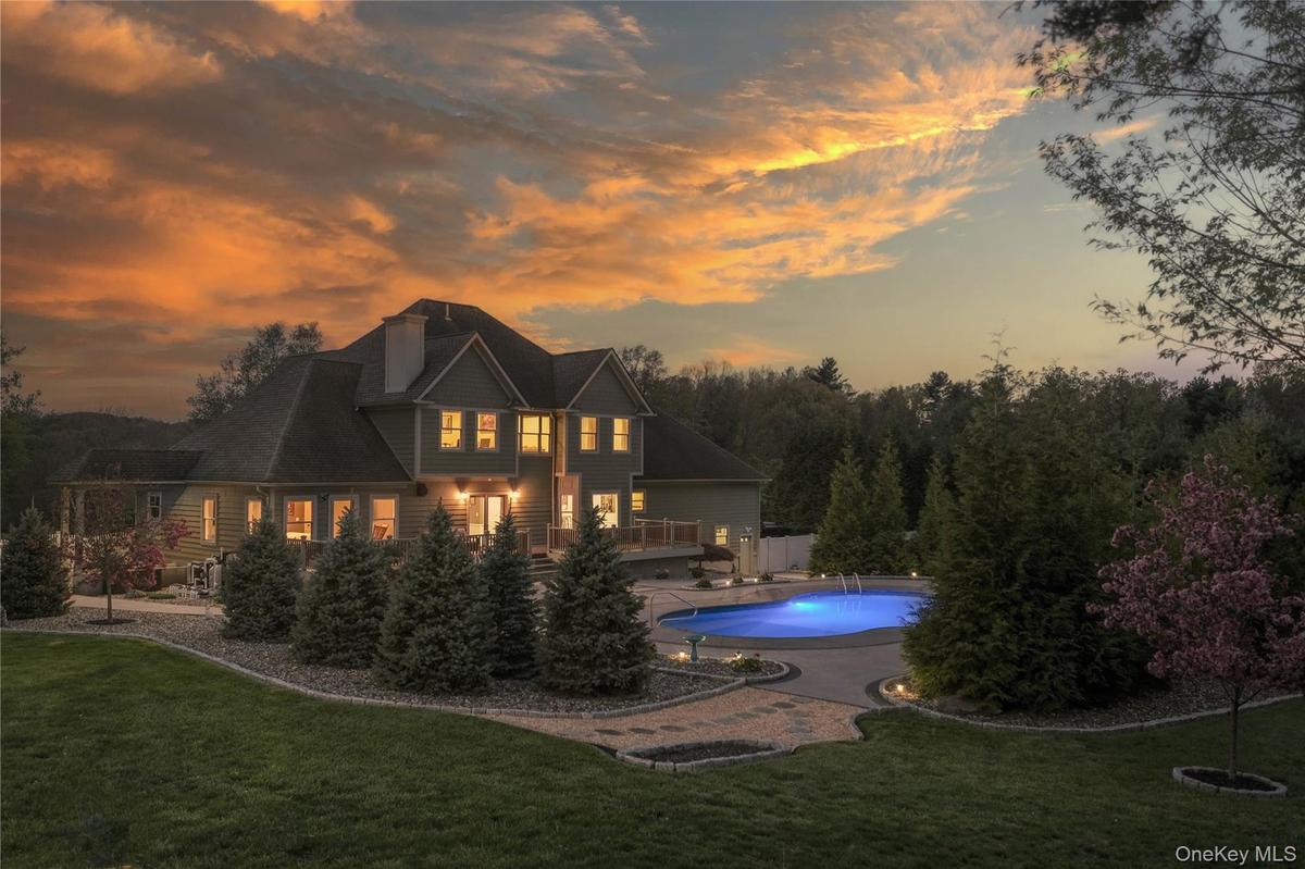 A backyard daydream, where a pristine pool and playful pops of luxury invite you to dive right in.