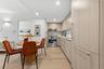 Dining area with light wood-style flooring and recessed lighting