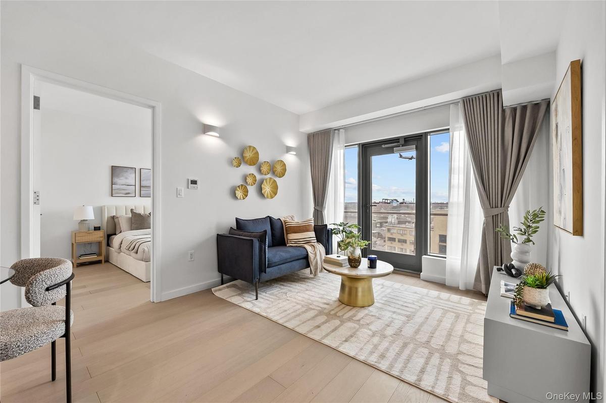 Sitting room featuring light wood-style flooring and baseboards