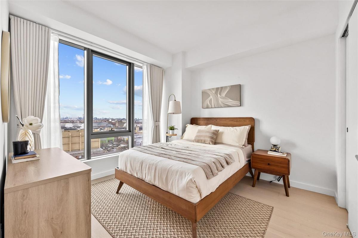 Bedroom featuring light wood-type flooring and a closet