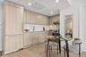 Kitchen with modern cabinets, light brown cabinets, light wood-style floors, stainless steel range, and recessed lighting