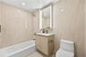 Full bath featuring vanity, shower / bath combination, tile walls, and recessed lighting