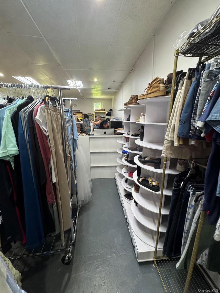 Walk in closet with a drop ceiling