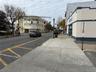 View of street with sidewalks, street lights, traffic signs, and curbs