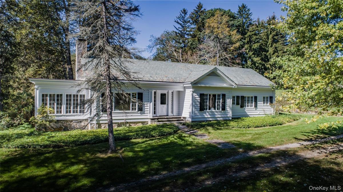 A 2,272 SF ranch-style home featuring 2 bedrooms, 1½ baths, generously sized rooms with high ceilings, and an enclosed porch.