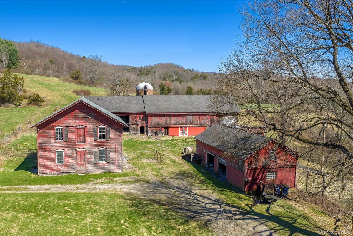 Iconic red barns and silo that define the property’s rural character.