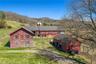 Iconic red barns and silo that define the property’s rural character.