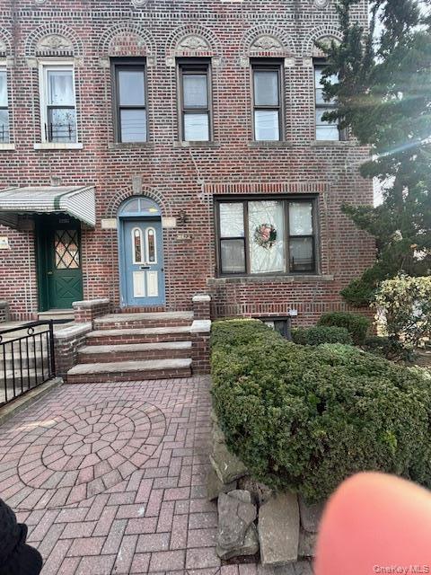 View of front of house featuring brick siding